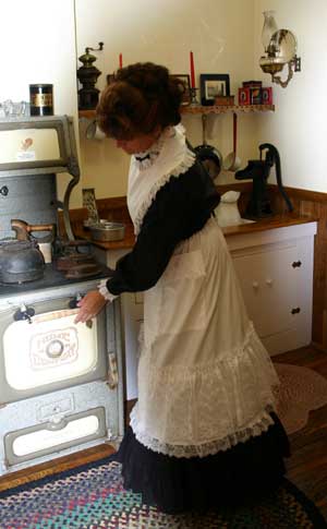 Lacy apron clad woman in the kitchen