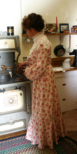Edwardian lady in calico at the stove
