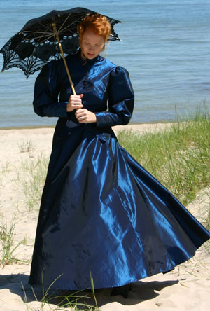 Victorian lady strolling on the beach