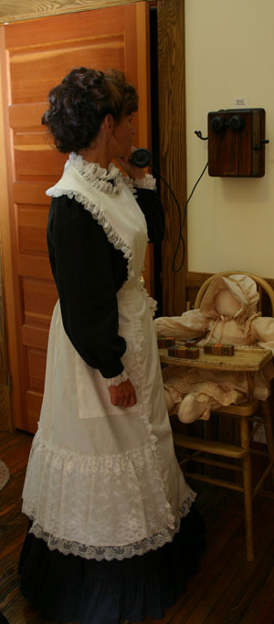 Lacy apron clad woman in the kitchen